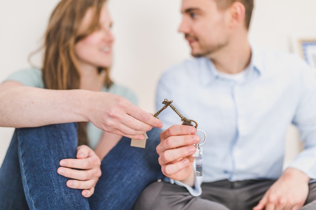 Couple holding keys to their new home