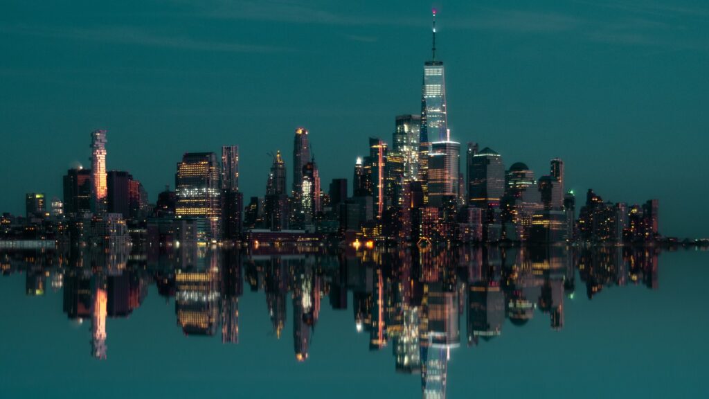 Manhattan skyline next to a body of water during the night