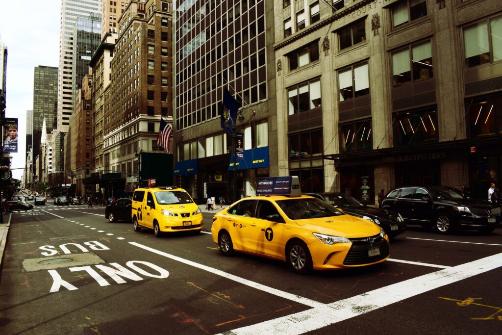 Two yellow taxis in the middle of the road in NYC